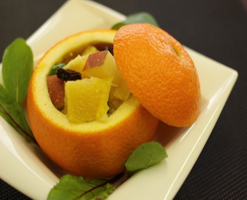 オレンジの皮を器にたオレンジやきゅうりが入ったオレンジカップサラダの写真